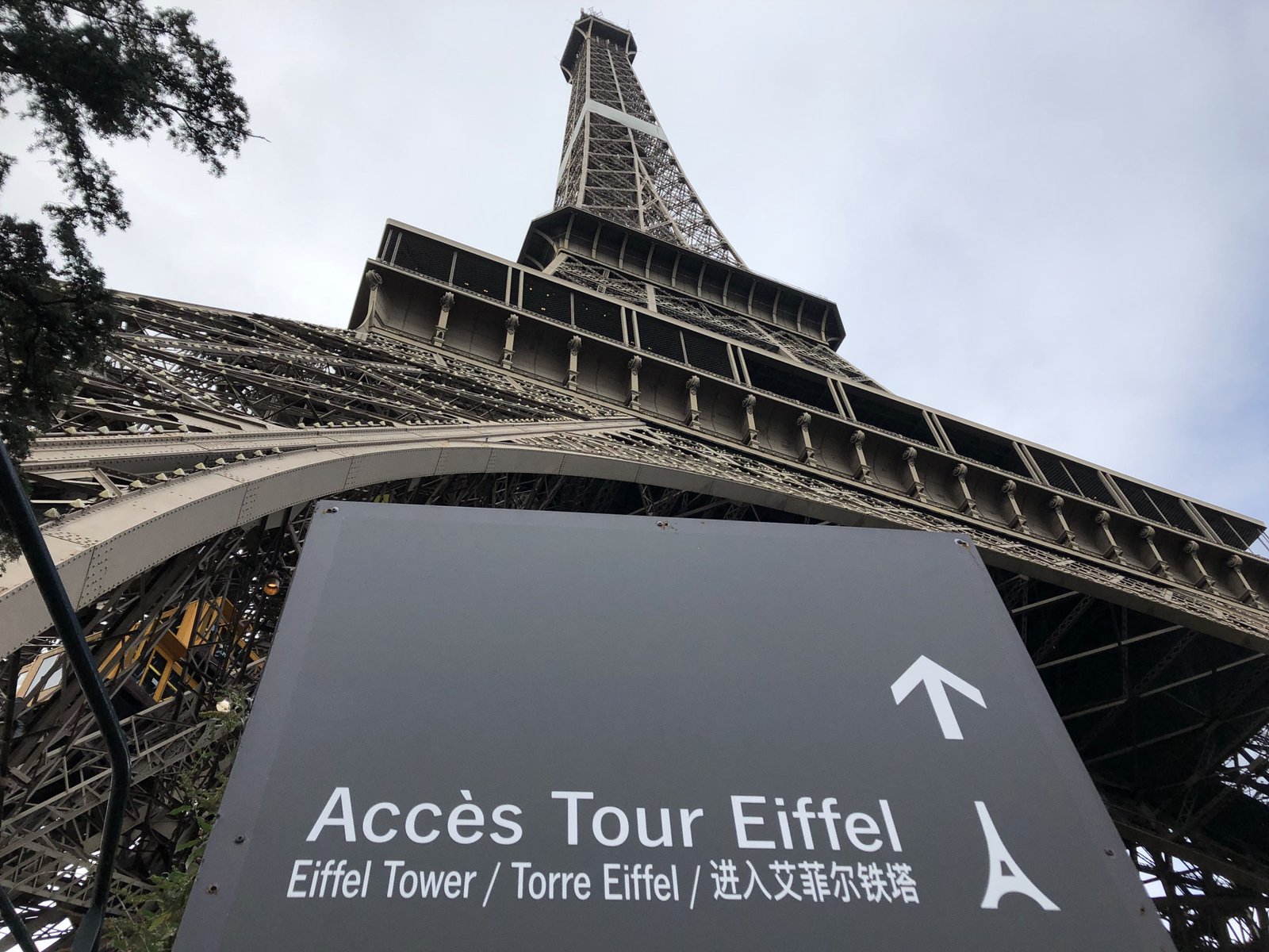 Image of the Eiffel Tower from the ground, with an Access sign